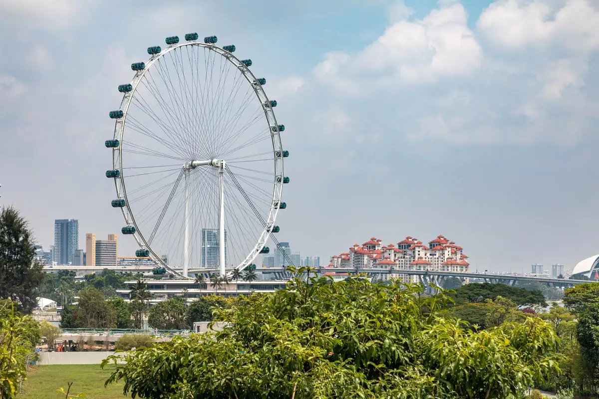 A Singapore Flyer capsule at the top of the rotation above Marina Bay