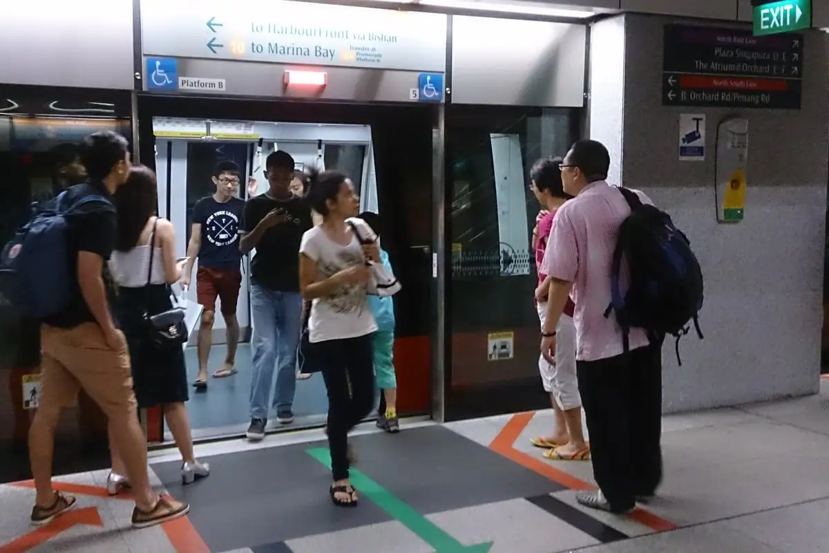Passengers boarding a train at Dhoby Ghaut MRT station in Singapore
